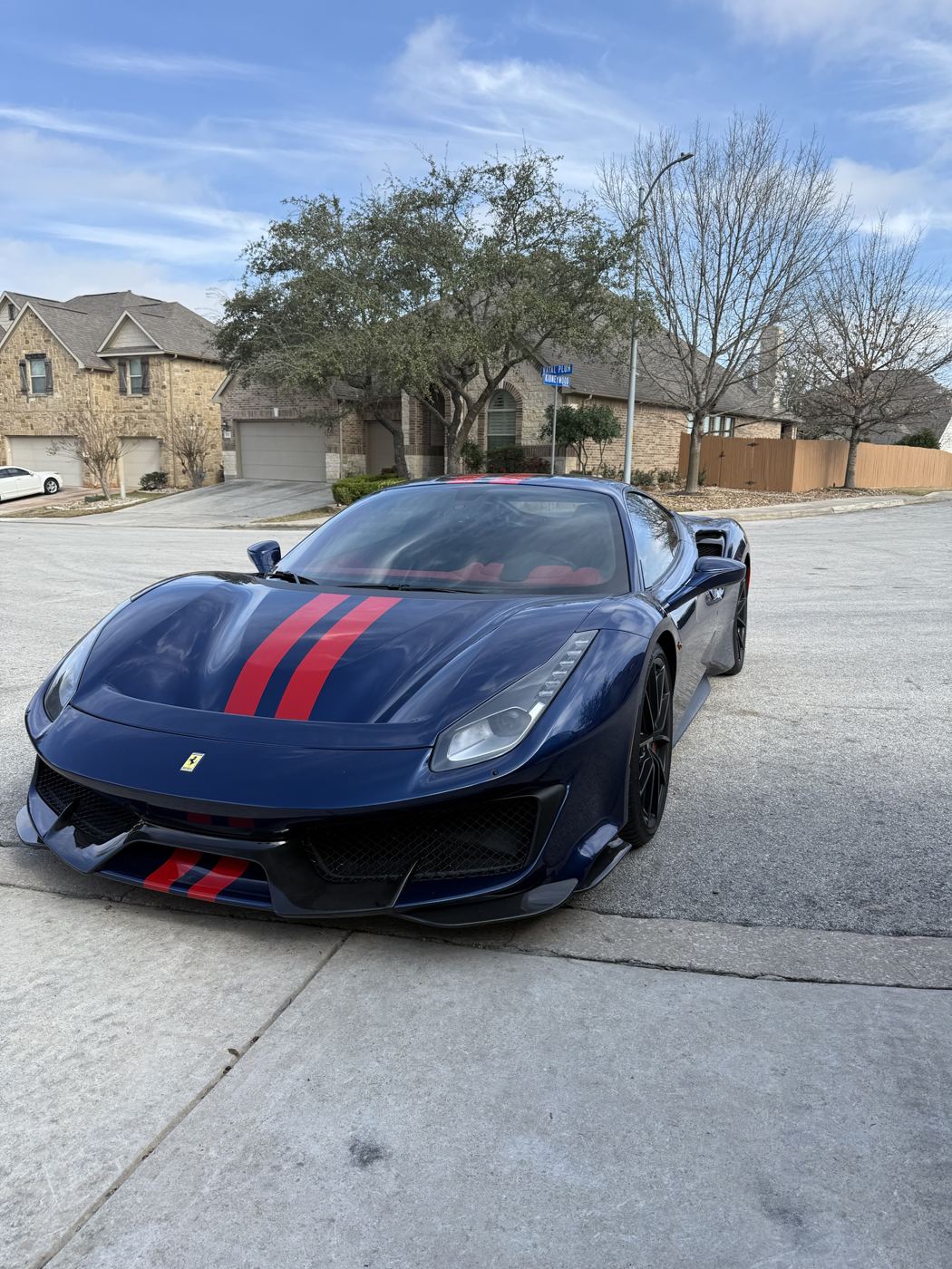 Blue Ferrari 488 Pista with red stripes, front view