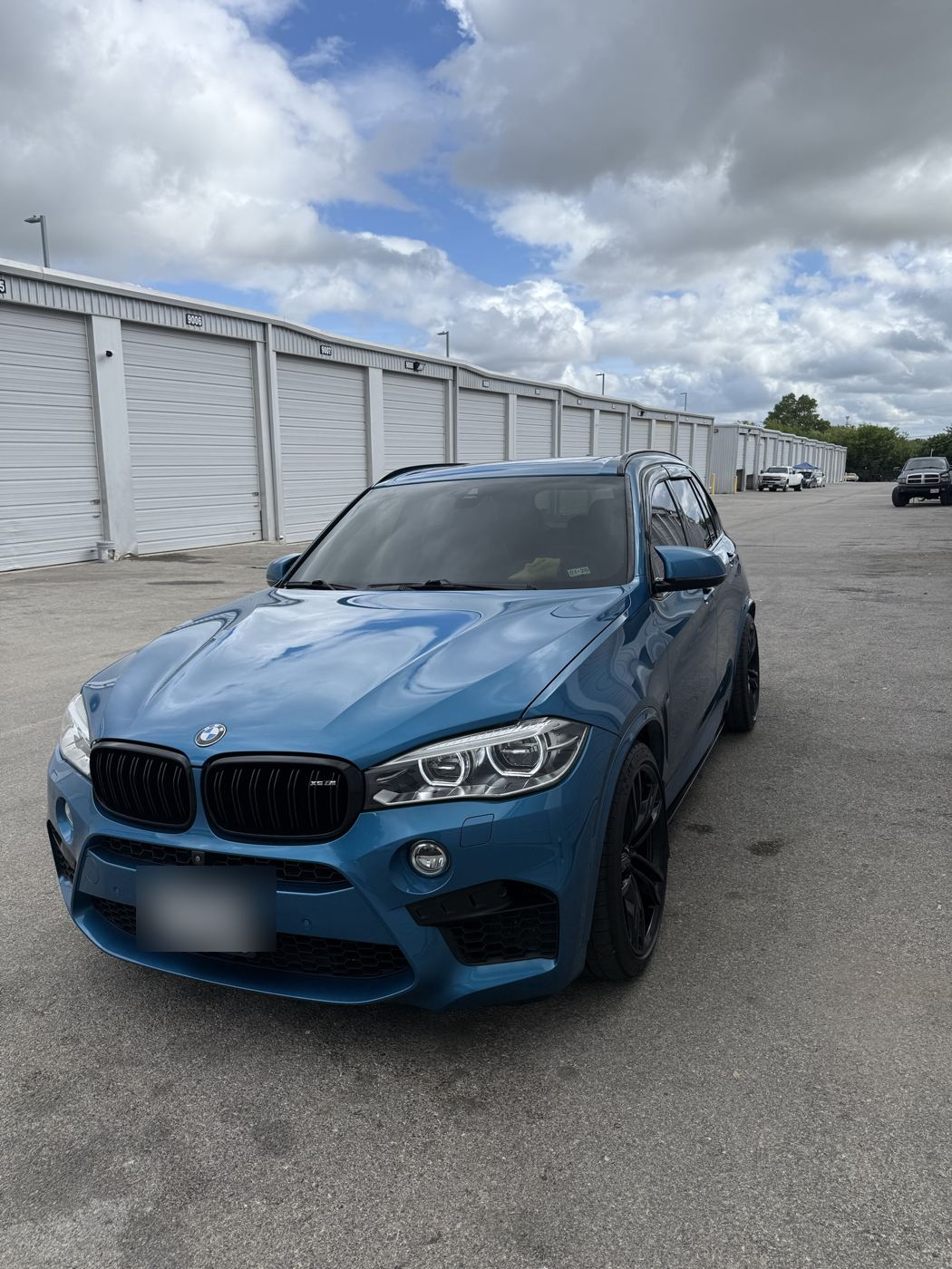 Blue BMW X5 M, front view with tinted windows